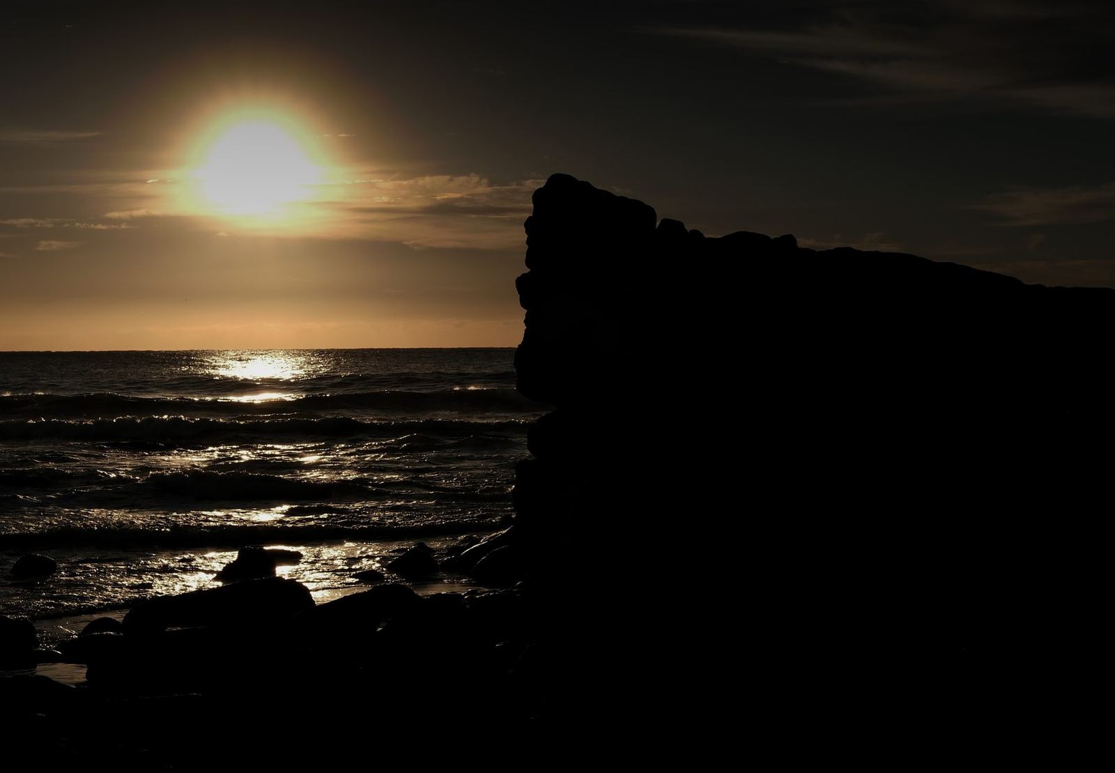 Rock silhouette, setting sun