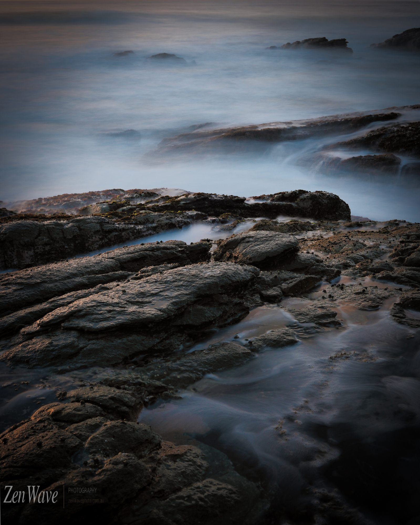 Blue hour, dark reef and still water