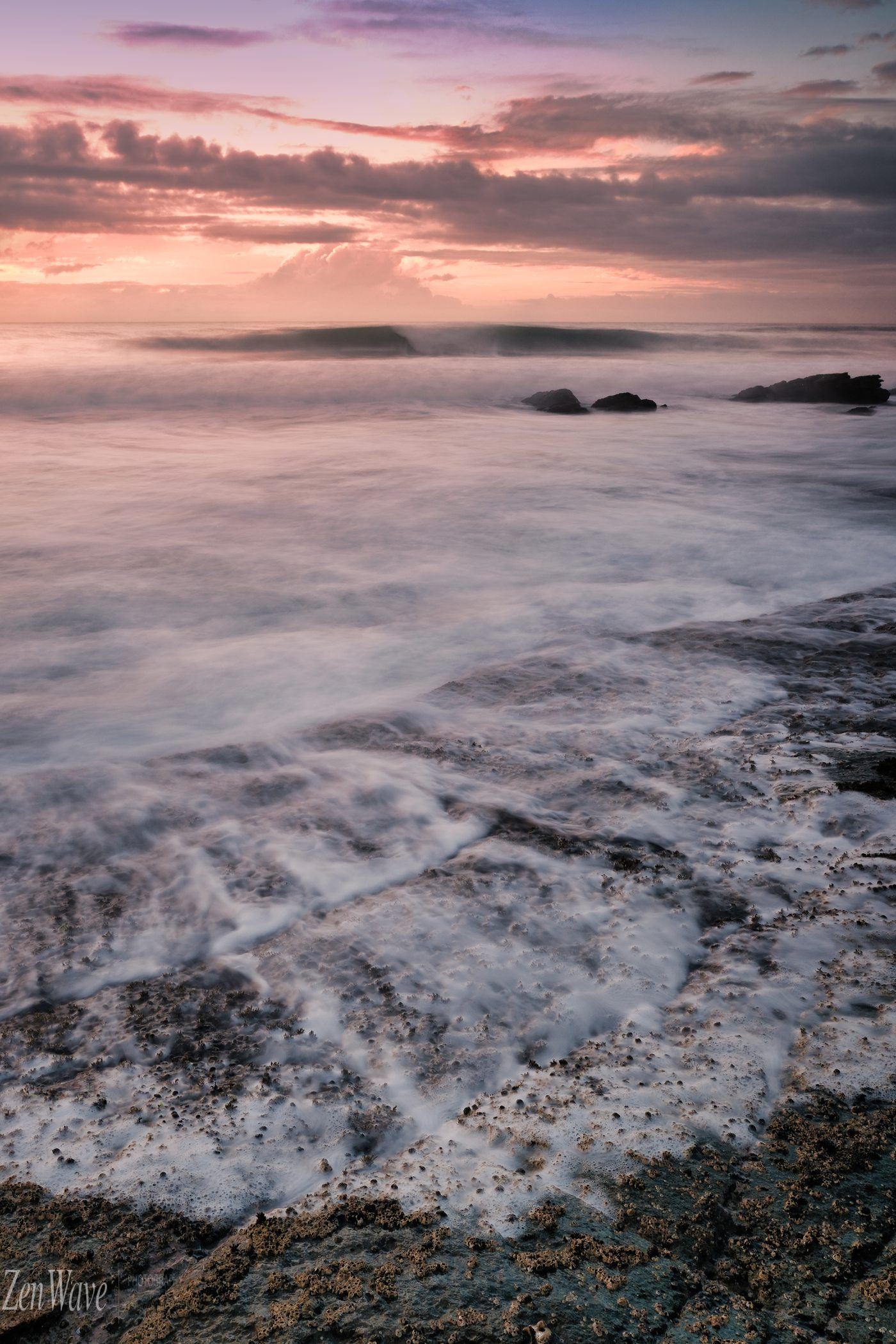 Pale pink wash, silky water over reef