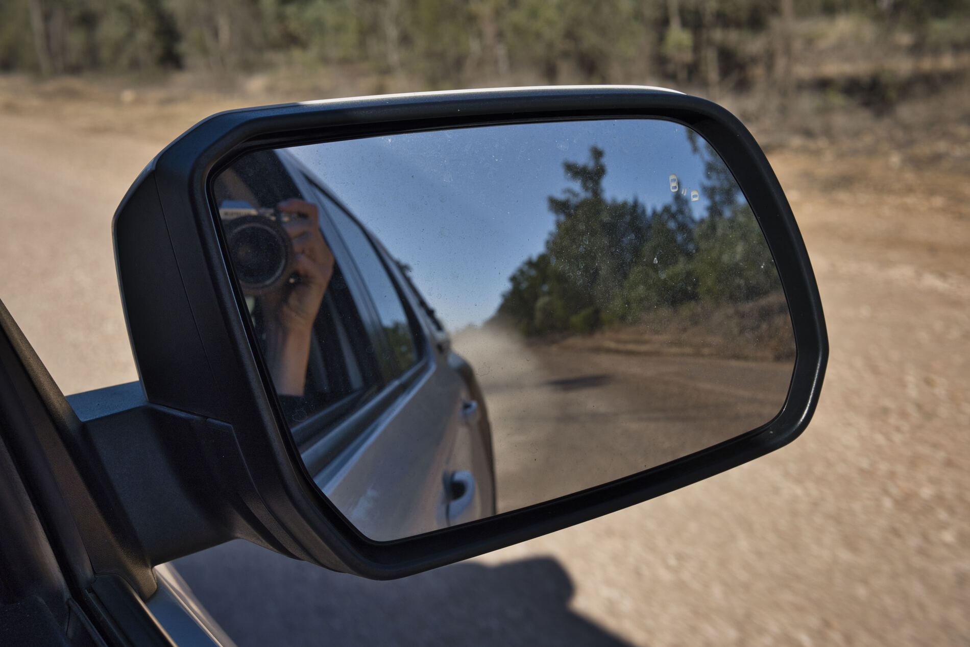 Dusty road in the side mirror